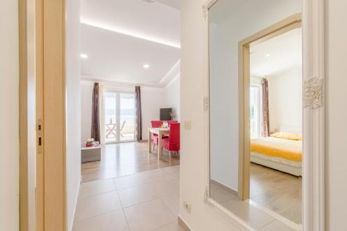 een slaapkamer met een bed en een spiegel bij Apartments by the sea Duce, Omis - 8378 in Dugi Rat