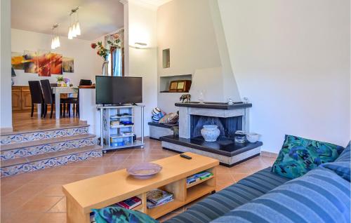 a living room with a couch and a fireplace at Stunning Home In S M Di Castellabate in Santa Maria di Castellabate