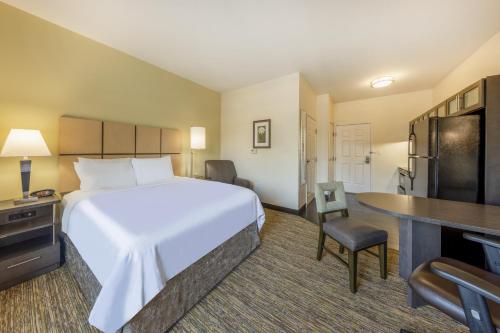 a hotel room with a large bed and a desk at Candlewood Suites Springfield-Medical District by IHG in Springfield