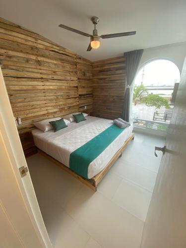 a bedroom with a bed with a wooden wall at NUEVO Depto vista al mar. in Boca del Río