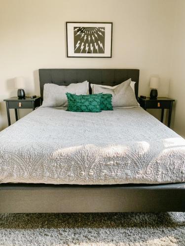 a bedroom with a large bed with two night stands at The Ruby - Modern Updated 4/2 Home Near ACU in Abilene