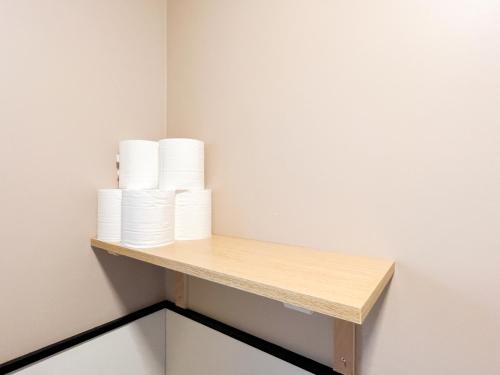 a shelf with toilet paper on a wall at Osaka Nipponbashi EVISU HOSTEL エビスホステル in Osaka