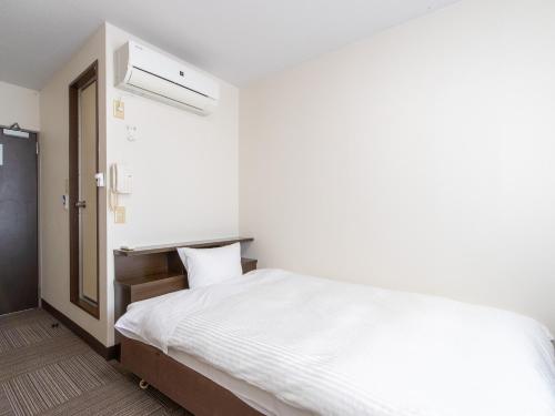 Postel nebo postele na pokoji v ubytování Tabist Rays Hotel Suisen