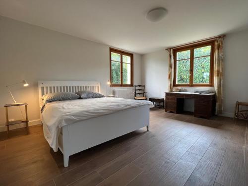 a bedroom with a bed and a desk and windows at Maison Évian-les-Bains, 6 pièces, 7 personnes - FR-1-498-79 in Évian-les-Bains
