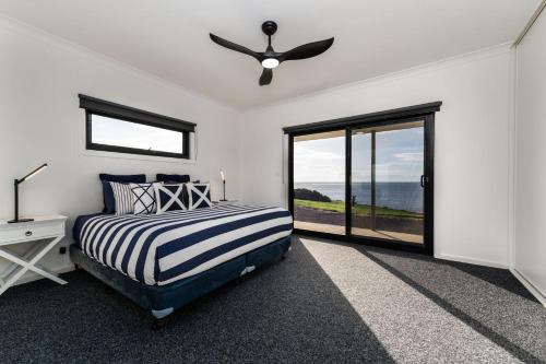a bedroom with a bed and a ceiling fan at Fairfield House 17 Rookery Road in Emu Bay