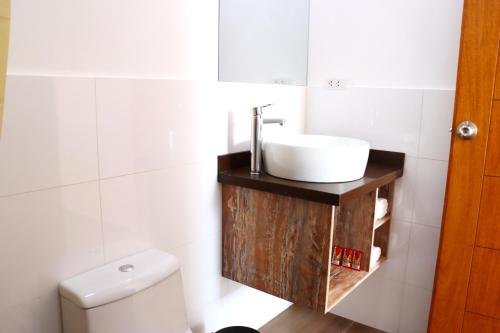 a bathroom with a sink and a toilet at La Estancia Hotel Ica in Ica