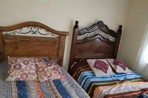 two beds sitting next to each other in a bedroom at Depto comodo centrico cerca a colegios;hospitales in Cochabamba