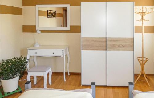 a bedroom with a white cabinet and a desk at Ferienwohnung Neustift in Neustift an der Lafnitz
