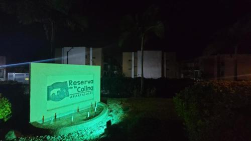 a sign in front of a building at night at APARTAMENTO en el QUINDIO in La Tebaida
