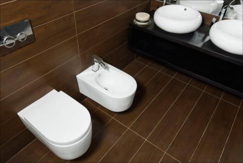 a bathroom with a toilet and a bidet and a sink at House Neza in Kranjska Gora