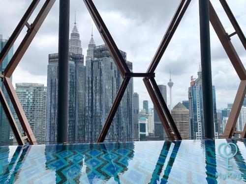 a view of the kuala lumpur city skyline from a swimming pool at Scarletz Suites KLCC by Mykey Global in Kuala Lumpur