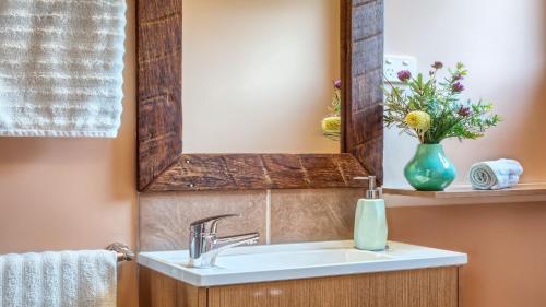 a bathroom with a sink and a mirror at Tea Tree Hollow in Canyon Leigh