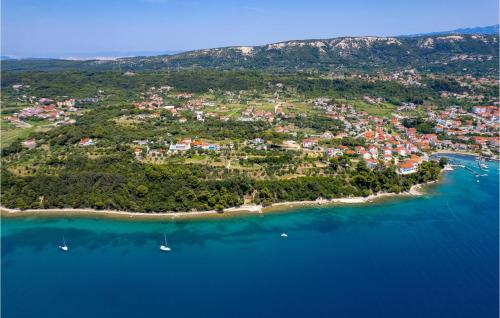 an island in the ocean with boats in the water at 1 Bedroom Awesome Home In Rab in Rab