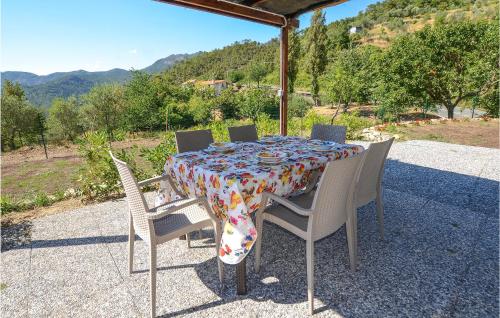 a table with chairs and a table cloth on it at Beautiful Home In Framura With Wifi in Framura