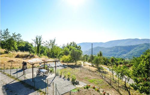 a garden with a gazebo and trees and mountains at Beautiful Home In Framura With Wifi in Framura