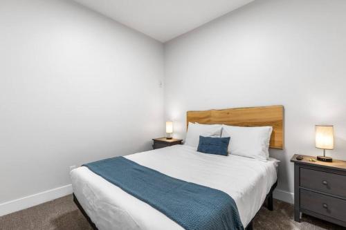 a bedroom with a large bed and two night stands at Beach Suites in Parksville