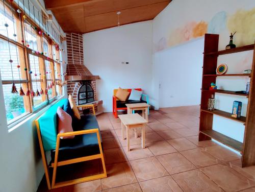 a living room with chairs and a fireplace at Casa Tribu in Huaraz