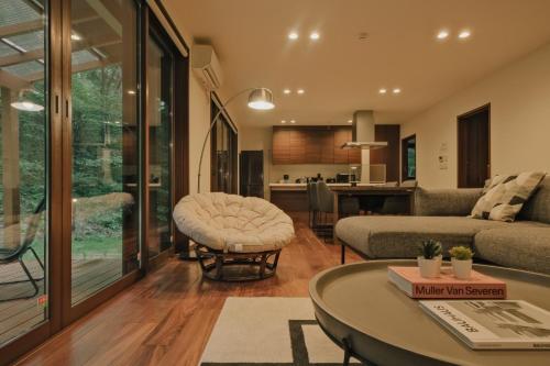 a living room with a couch and a table at Fandina藤原 in Azumaiokozan