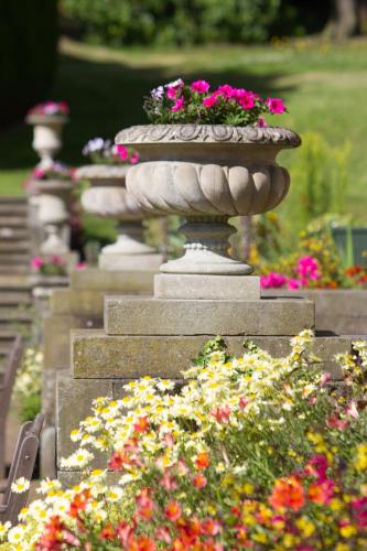 a row of stone vases filled with flowers at Wortley Hall Sheffield in Sheffield