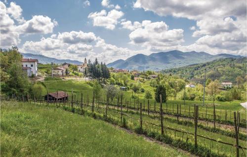 a fence in a field with mountains in the background at Cà Da Suntina in Varese Ligure