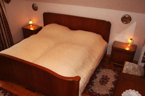 a bedroom with a large bed with two night stands at Haus Prilblume in Detern