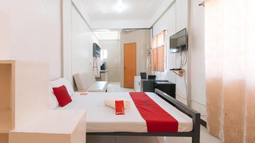 a room with a bed and a tv in it at RedDoorz near Tambo Quirino Avenue in Manila