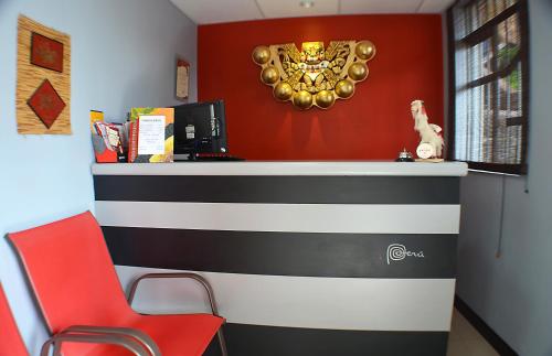 a office with a desk with a red wall at Wifala Thematic Hotel Boutique in Cusco