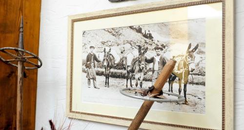 a framed picture of a horse and riders at Hôtel La Grange Aux Marmottes in Viscos