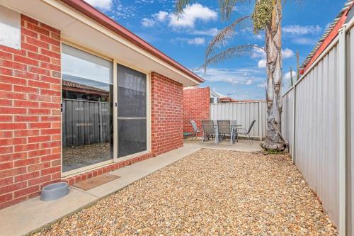 a brick building with a window and a patio at Sleepy Shackell - Echuca Moama Holiday Accommodation in Echuca