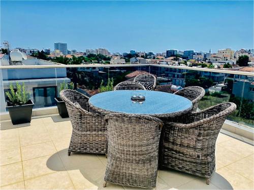 a table and chairs on top of a balcony at The Penthouse 401 in Larnaka