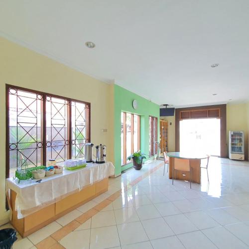 a large room with a kitchen and a table at Candi Panggung Family Guest House Syariah in Malang
