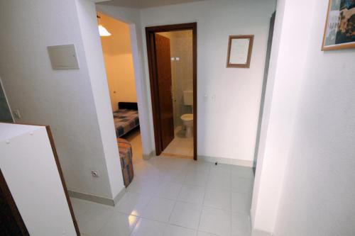 a hallway with a bathroom and a toilet in a room at Apartments by the sea Sumpetar, Omis - 4827 in Jesenice