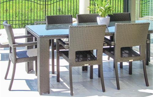 a wicker table and chairs on a patio at Nice Apartment In Grzybowo With Kitchenette in Grzybowo