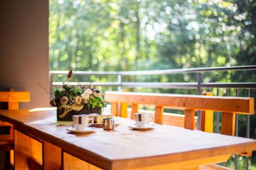 a wooden table with two coffee cups on it at Chaty Ferrata in Martin