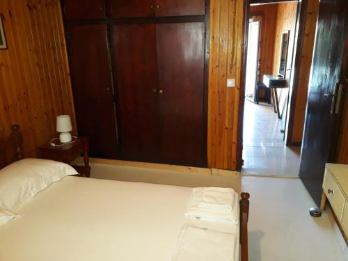 a bedroom with a bed and a large window at Akis Apartments Kontogialos-Pelekas in Pelekas