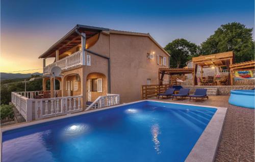 a house with a swimming pool in front of a house at Pet Friendly Home In Donji Zagon in Donji Zagon