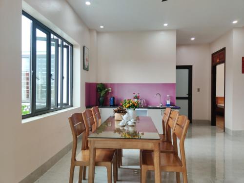 a dining room with a wooden table and chairs at GiaBinh Homestay in Cao Bằng