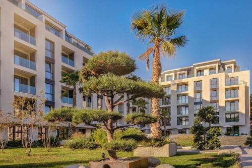 a building with a palm tree in front of it at ALLURE VARNA studios in St. St. Constantine and Helena