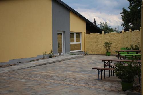 a patio with benches and tables in front of a building at Hotel/Pension Rast& Ruh in Zodel