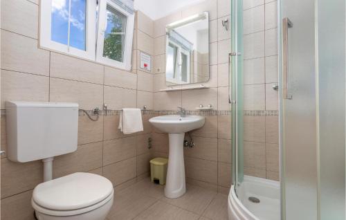a bathroom with a toilet and a sink and a shower at Lovely Apartment In Pinezici With Outdoor Swimming Pool in Pinezici