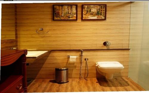 a bathroom with a toilet and a sink at The Emerald Club ,Rajkot in Rajkot
