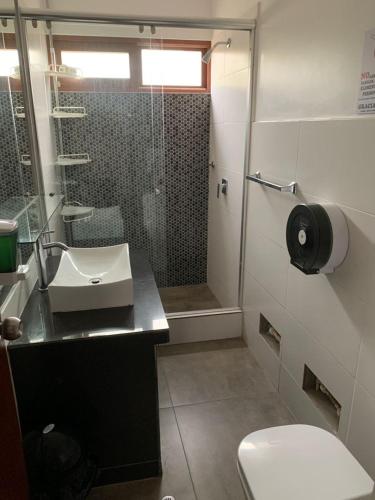 a bathroom with a toilet and a sink and a shower at Cieneguilla Eco House in Cieneguilla