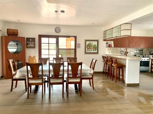a kitchen and dining room with a table and chairs at Cieneguilla Eco House in Cieneguilla