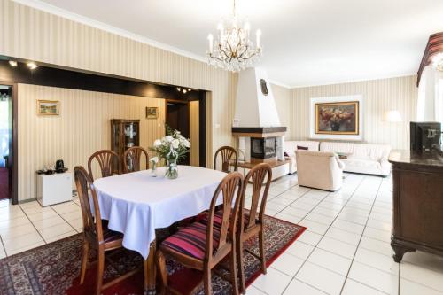 a dining room with a white table and chairs at Rezydencja Czantoria & Spa in Ustroń