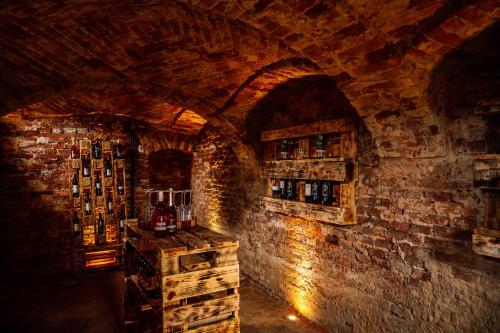 a wine tasting room with a brick wall at Landhaus dasThomas in Henndorf 
