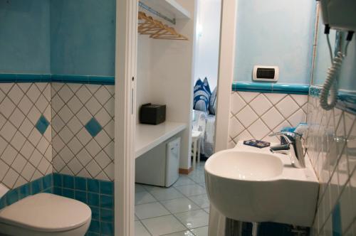 a bathroom with a white sink and a toilet at Guest House Villa Il Gabbiano in Ponza