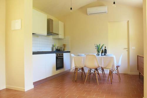 a kitchen with a table and chairs in a room at Casa Barulli - Tuscany in San Giovanni Valdarno