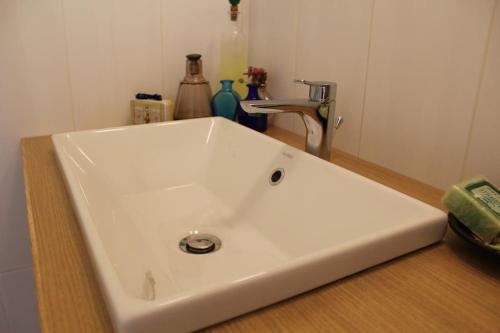 a white bathroom sink sitting on top of a counter at Casa Barulli - Tuscany in San Giovanni Valdarno