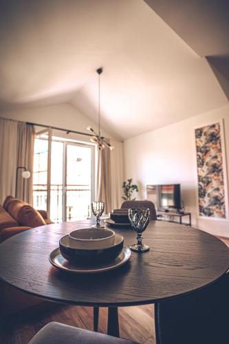 a dining room table with plates and glasses on it at THE LOFT - Garncarska 1 in Piotrków Trybunalski