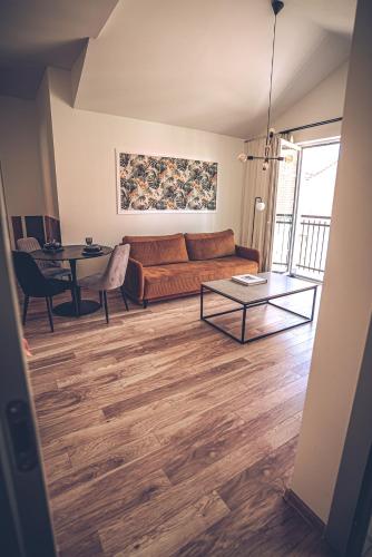 a living room with a couch and a table at THE LOFT - Garncarska 1 in Piotrków Trybunalski